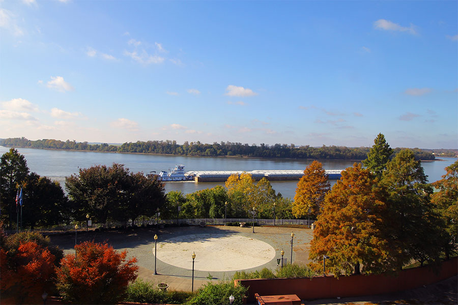 Evansville IN - Scenic View of a River with a Ship Surrounded by Colorful Fall Foliage in Evansville Indiana